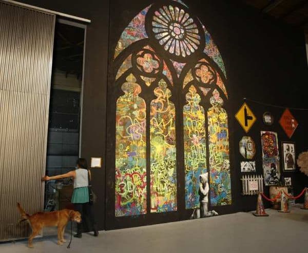 6a00d8341c630a53ef014e60f5a54e970c-600wi via LA Times Stained window by Bansky via LA Times as seen on Art Is Everywhere
